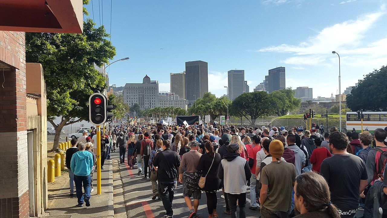 A crowd marching down a street in Cape Town