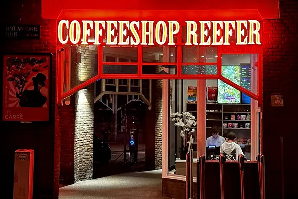 The front of a coffeeshop on a street in Amsterdam