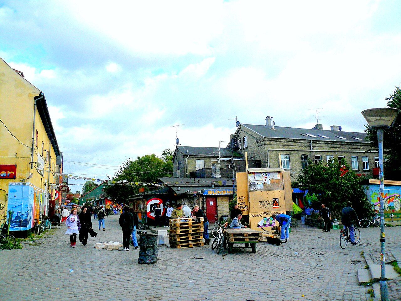 A cobbled street in Christiania lined with stalls and old buildings