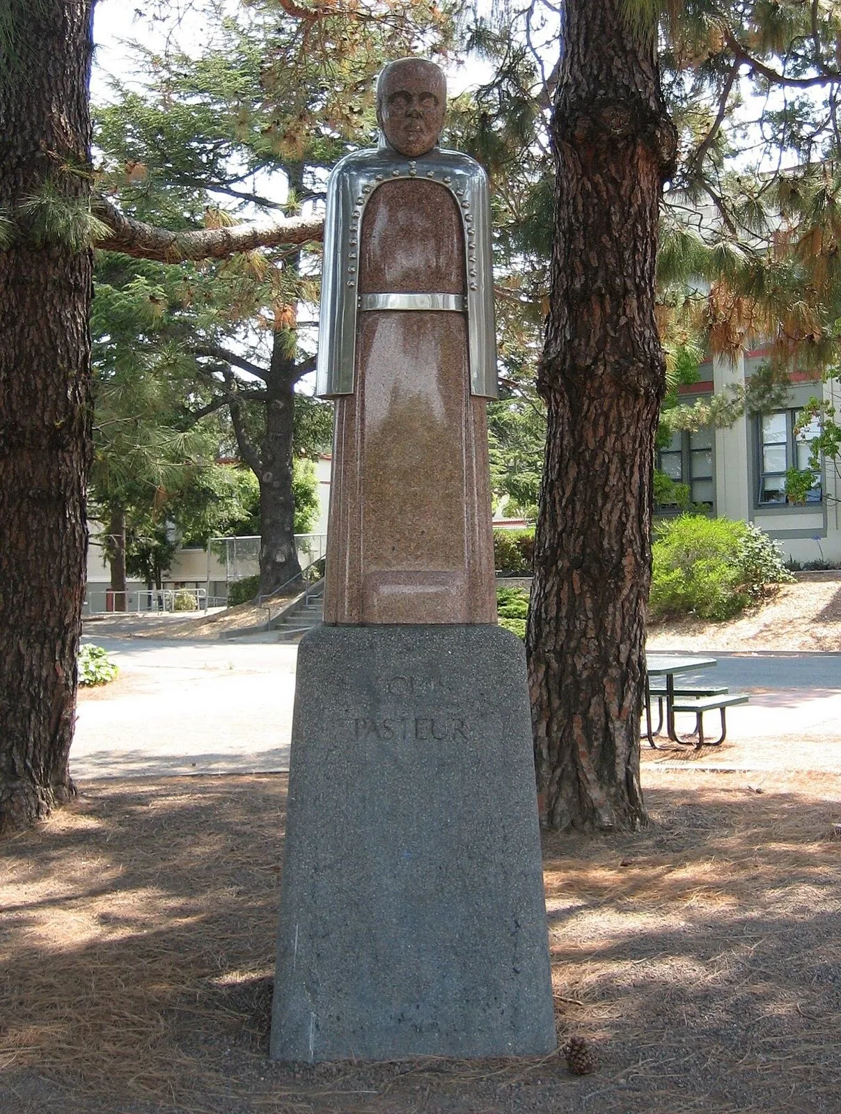 A statue of Louis Pasteur in the grounds of a school