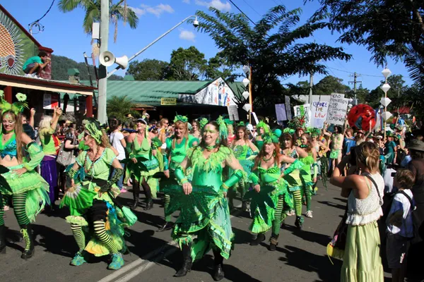 Dancers in green costumes in a street parade