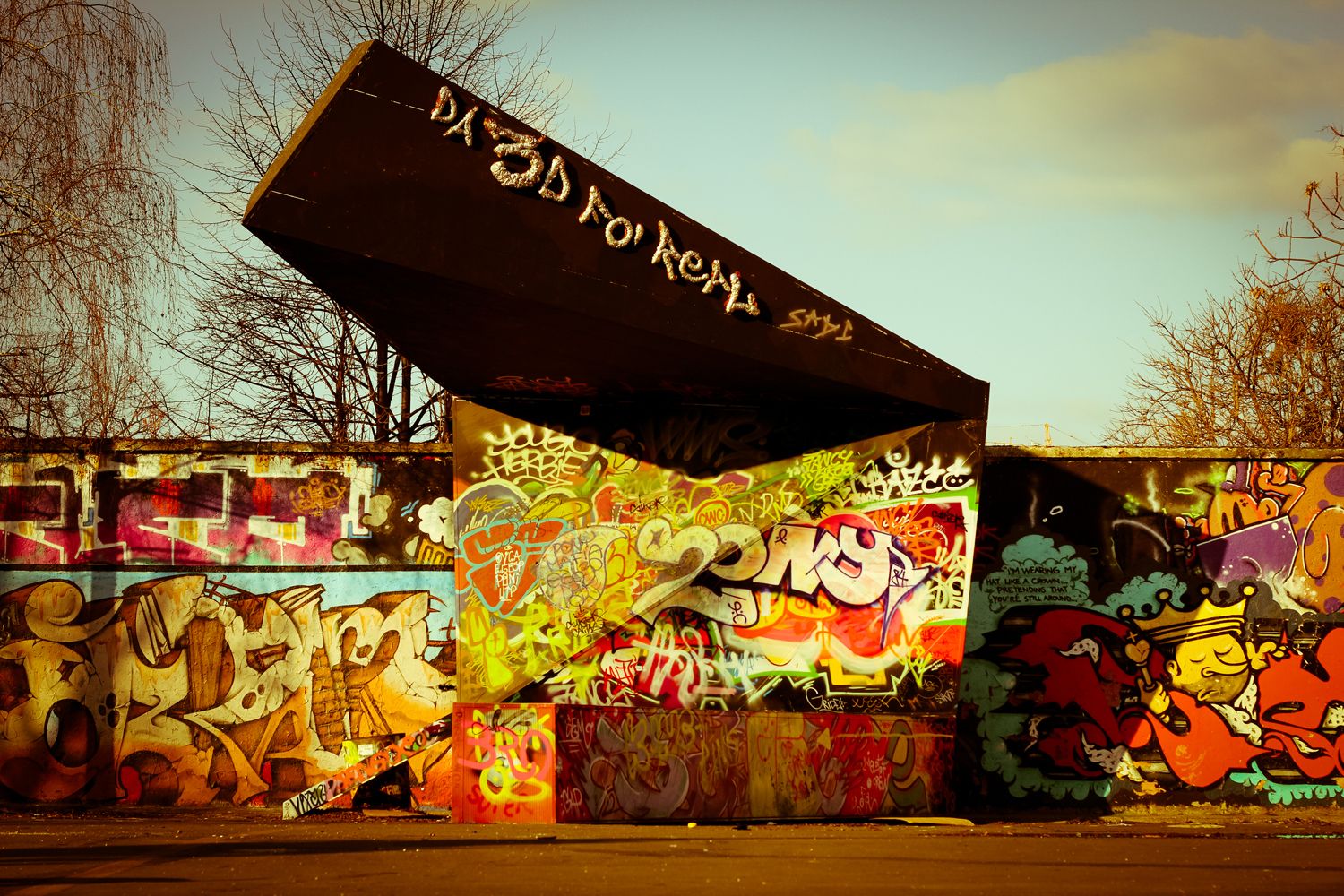 A graffiti-covered wall and sculptural metal structure at Metelkova in Ljubljana.