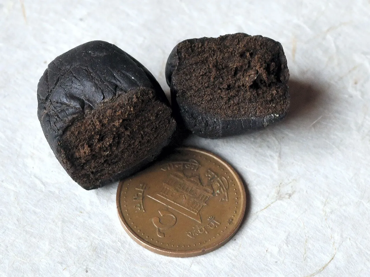 A dark brown lump of hand-rubbed cannabis resin