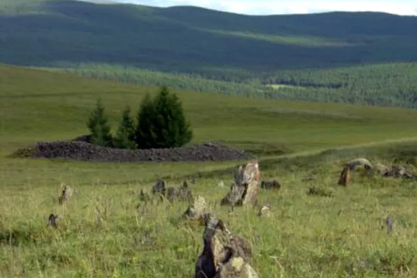 Low stone burial mounds in a mountain valley