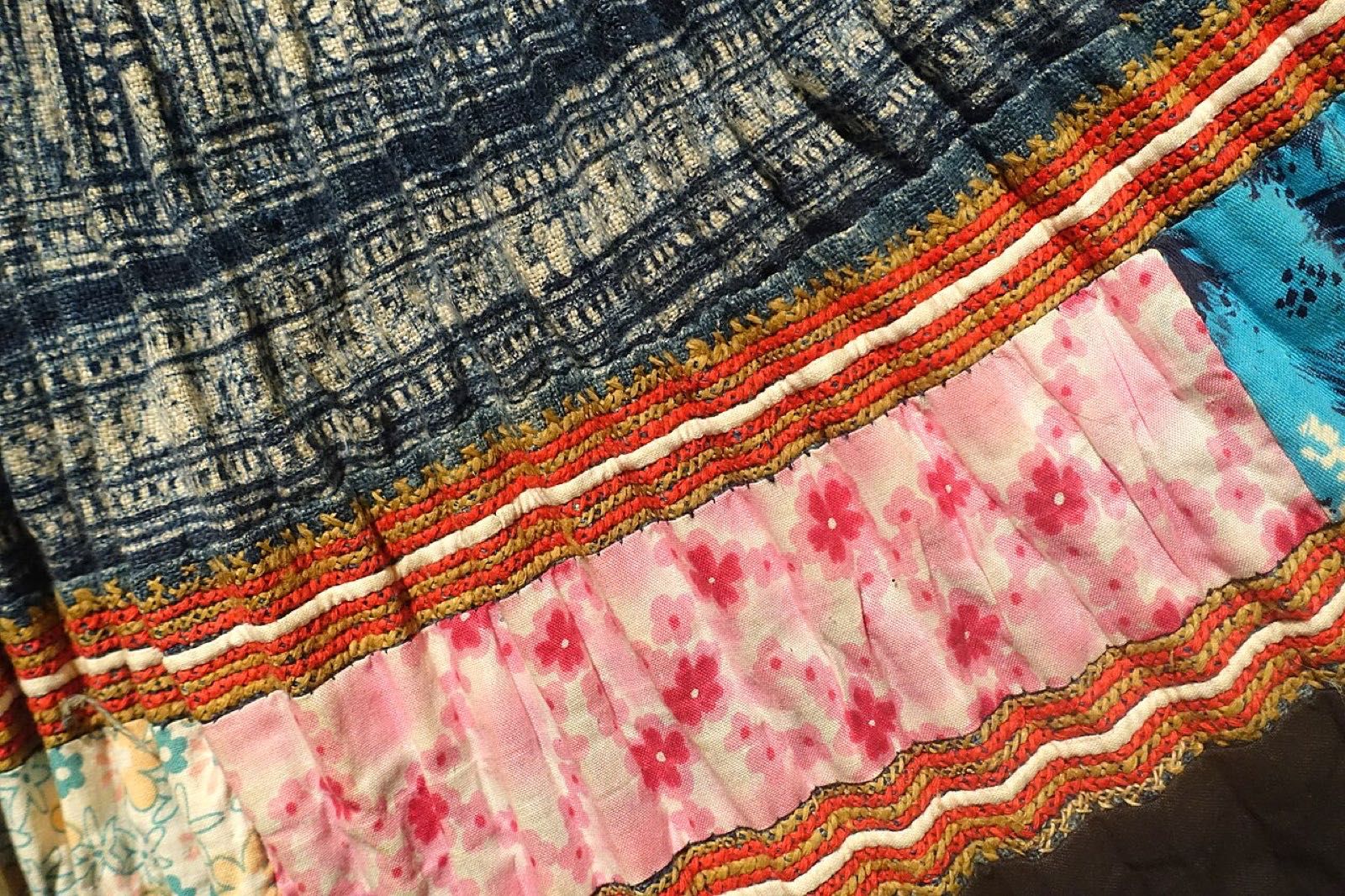 A pleated skirt of indigo batik hemp with bands of embroidery