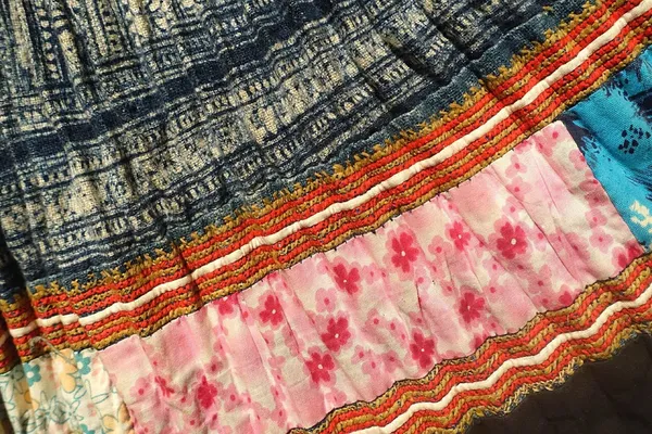 A pleated skirt of indigo batik hemp with bands of embroidery