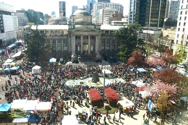 A large crowd gathered in a city square